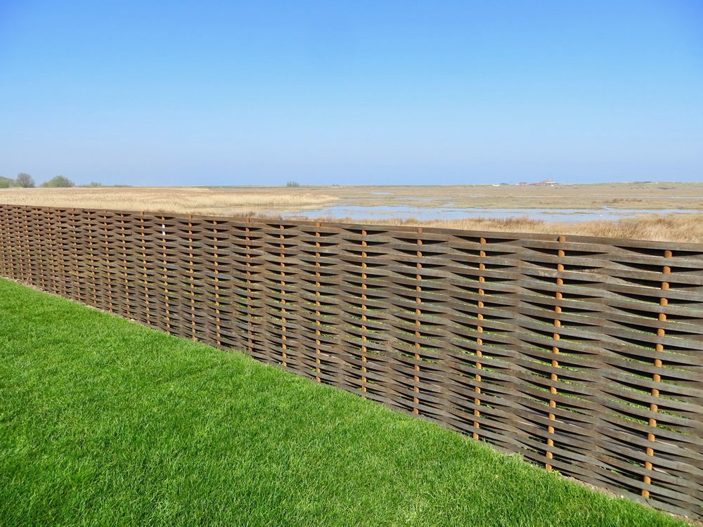 woven steel boundary fences near marsh